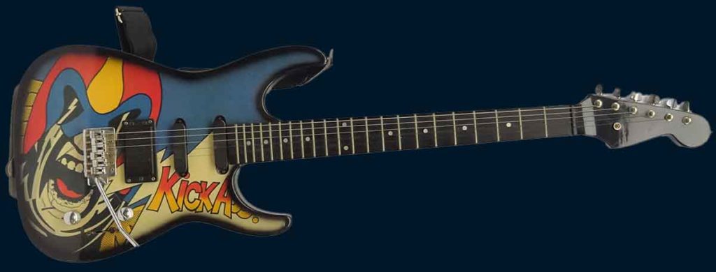 Image of an electric guitar with a dark blue background, the guitar is decorated with an image of Judge Dredd