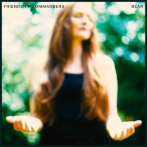 Friendship Commanders Bear album cover featuring a pixelated image of vocalist Buick Audra with hands raised, set against a green background.