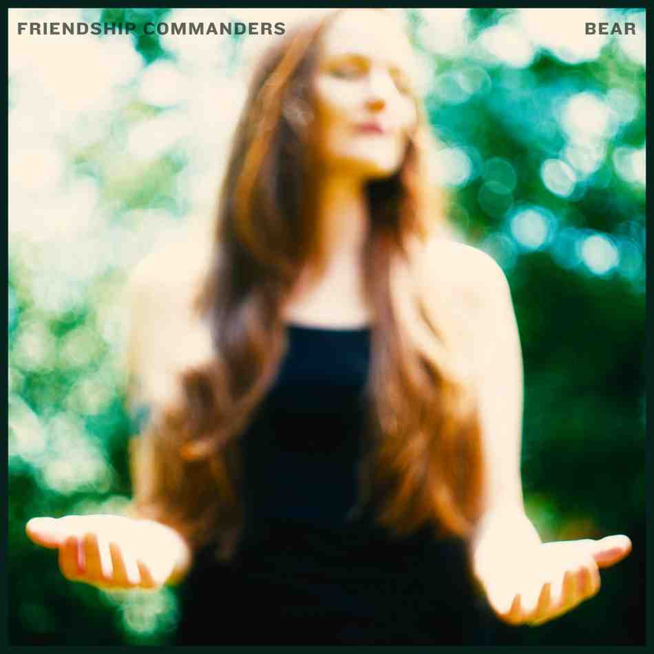 Friendship Commanders Bear album cover featuring a pixelated image of vocalist Buick Audra with hands raised, set against a green background.