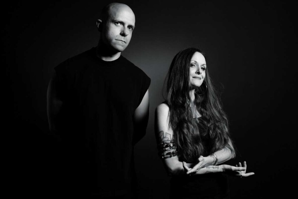 Black and white photo of Jerry Roe and Buick Audra of Friendship Commanders standing against a dark background, both looking confidently at the camera.