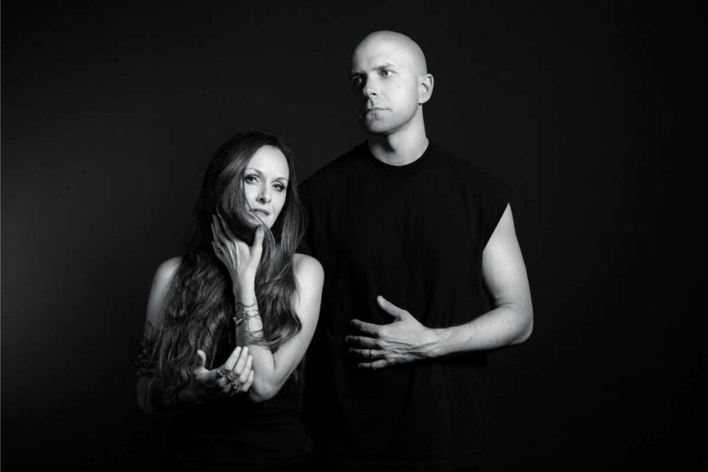 Black and white portrait of Friendship Commanders featuring Buick Audra looking into the camera while Jerry Roe looks away, set against a dark background.