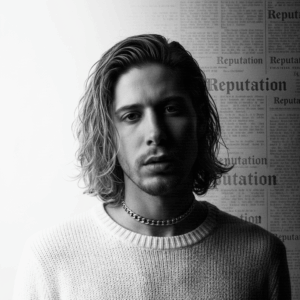 ShiShi portrait in black and white wearing a round neck jumper with long hair and layered poster style text background